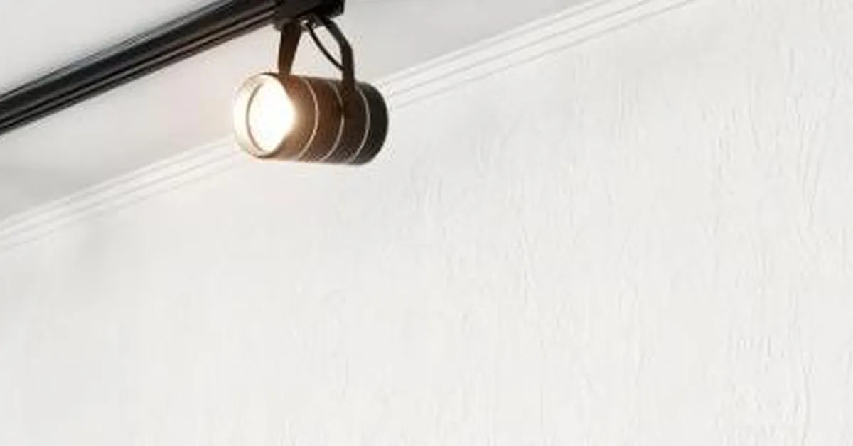 Track lighting head clipped onto an electrified ceiling track showing how track lighting works