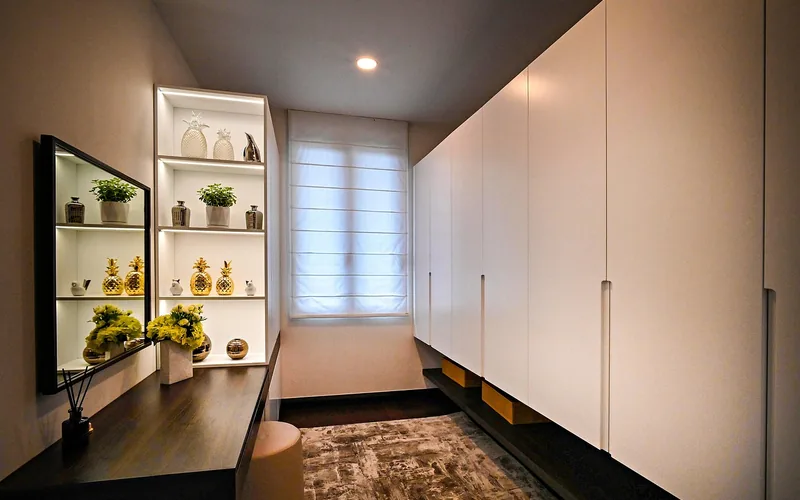 Built-in closet wardrobe with tall panel doors and long vertical pull handles in a bedroom Built-in closet wardrobe with tall panel doors and long vertical pull handles in a bedroom