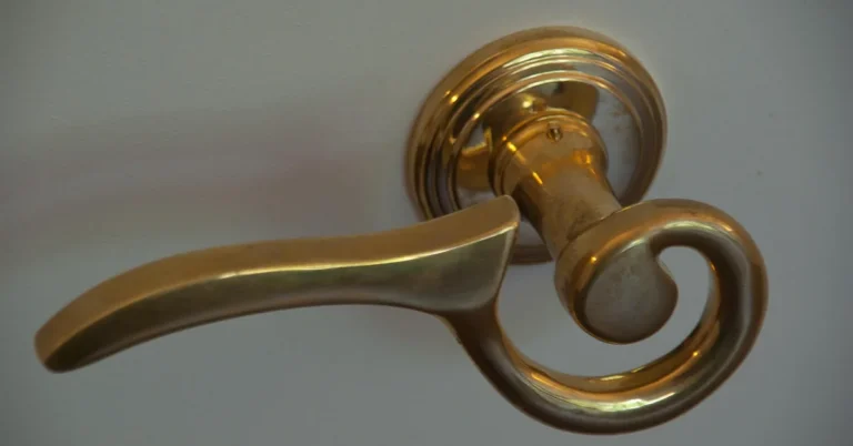 brass lever door handle mounted on a rosette base plate