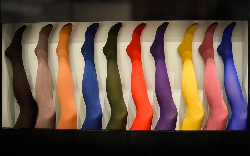 colorful opaque tights displayed in a range of shades on a store rack colorful opaque tights displayed in a range of shades on a store rack