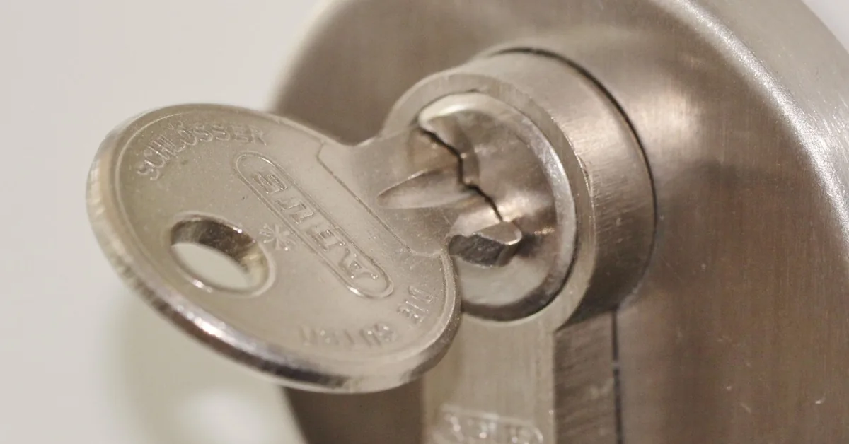 key inserted into a door deadbolt lock cylinder