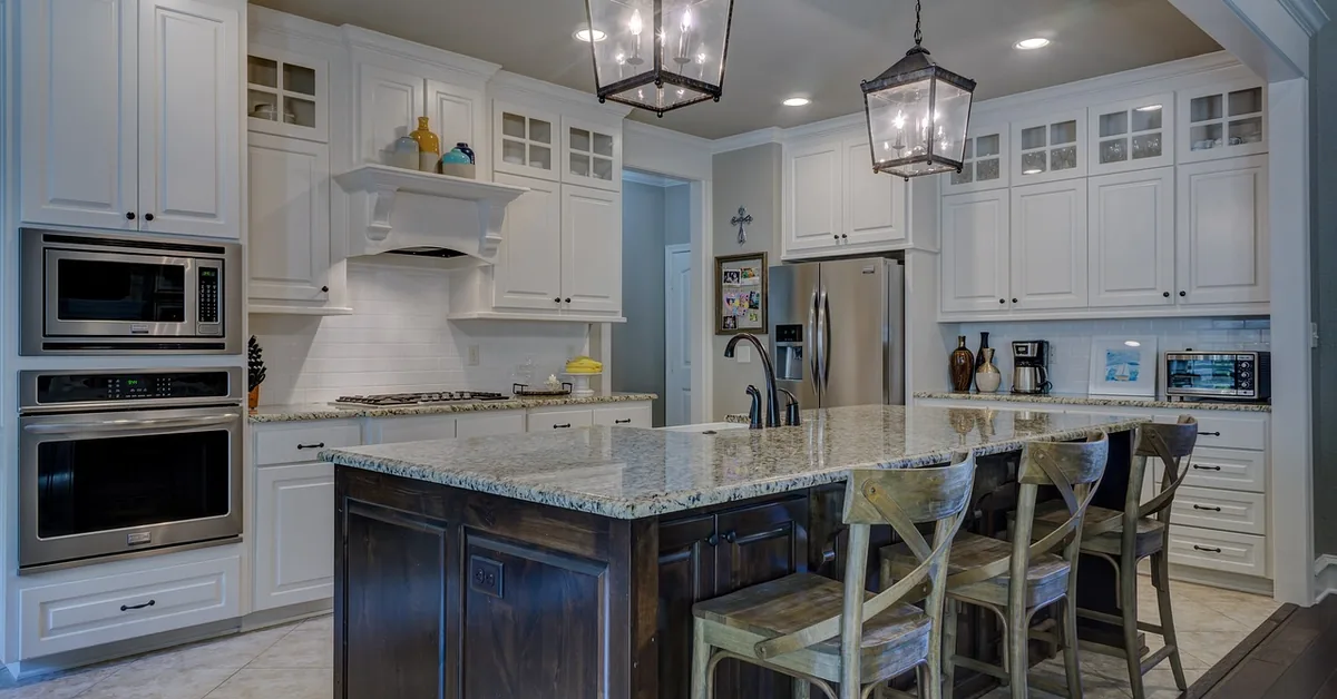 two lantern-style pendant lights hanging above a kitchen island