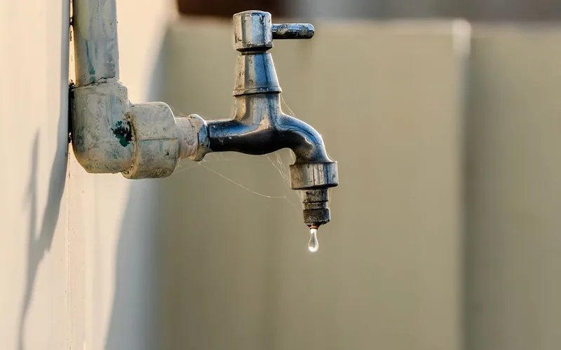 A dripping outdoor faucet spigot