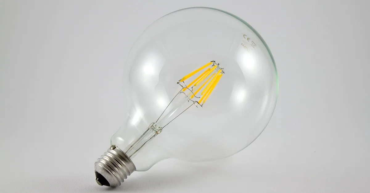 clear LED filament light bulb with visible warm LED filament strands