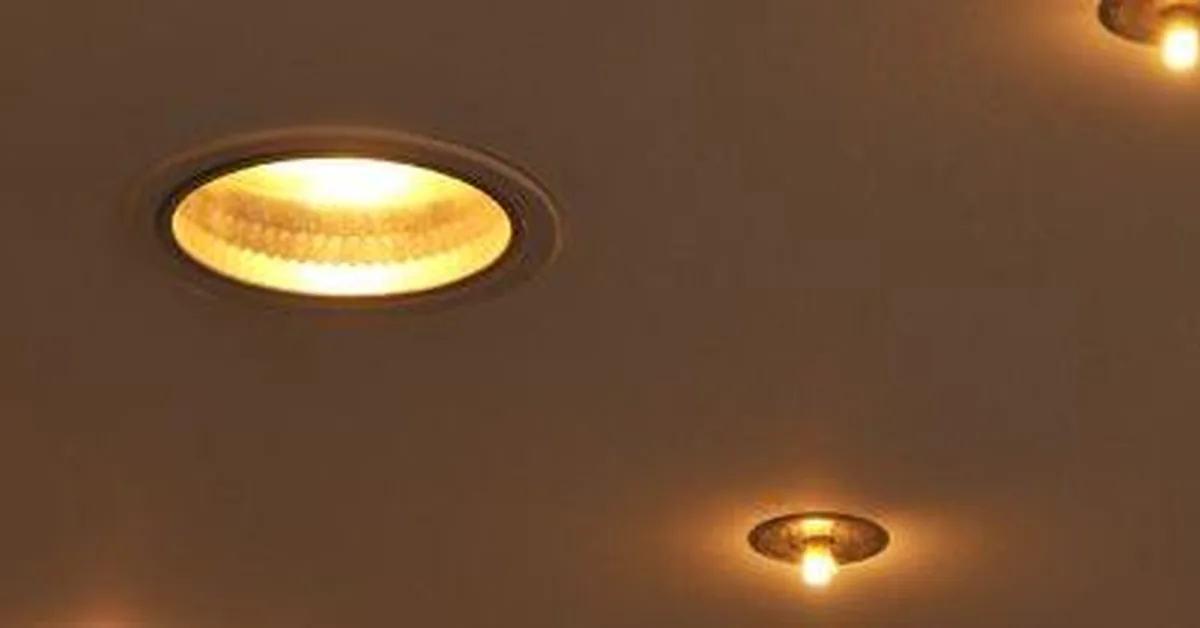 Multiple round LED recessed lights glowing in a flush white ceiling