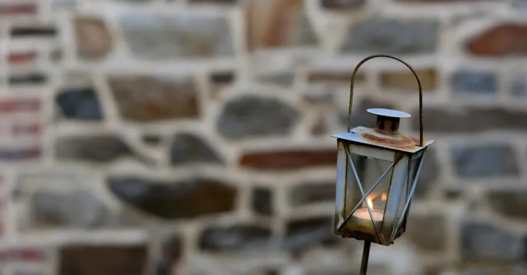 Rust spots forming on a metal light fixture cap where the protective coating has worn away