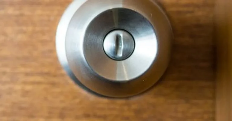 Round metal door knob and deadbolt where a Safety 1st cover attaches for child safety