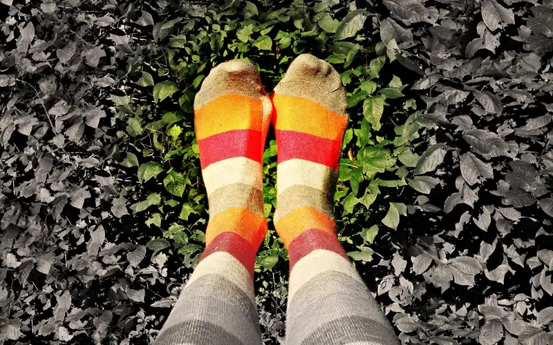 striped knee-high socks worn outdoors for a playful winter look striped knee-high socks worn outdoors for a playful winter look