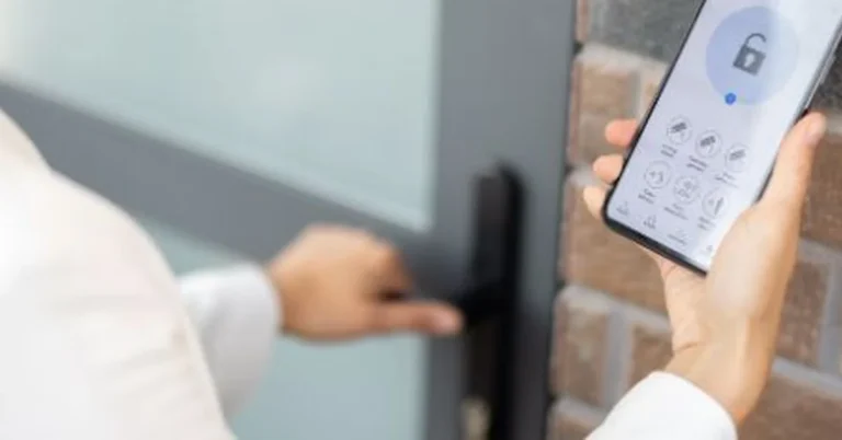 Hand holding a phone with the lock app open next to a Teeho smart door lock