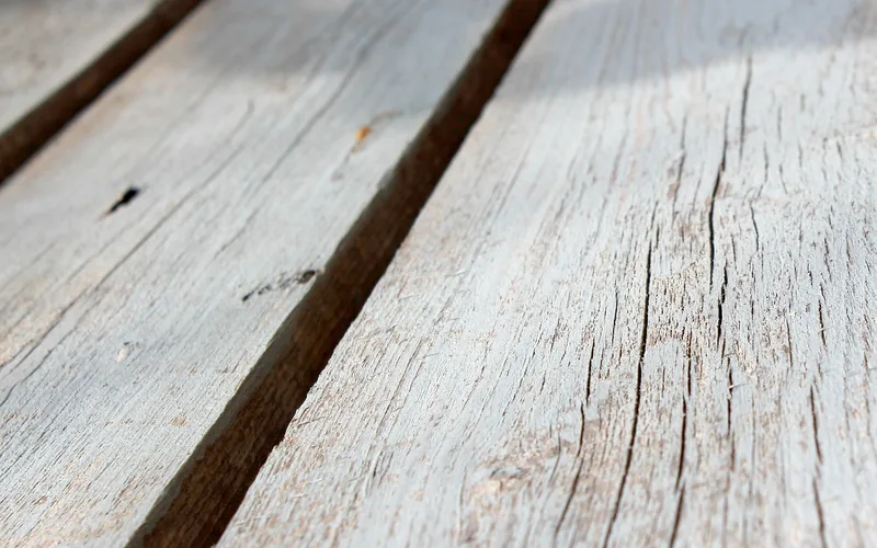 close-up of an even gap between two pressure-treated deck boards