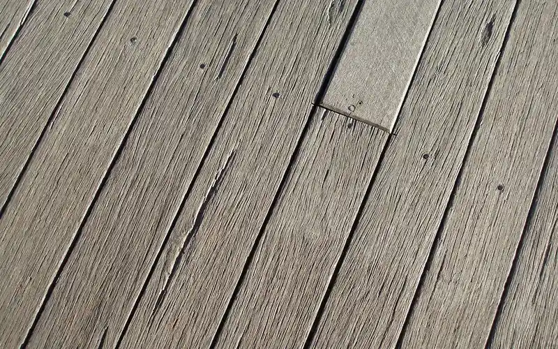 weathered deck boards with an even drainage gap between each plank