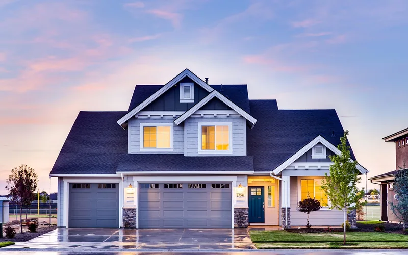 house exterior with porch and entry lights on at dusk