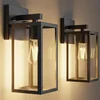 Kalium matte black porch wall sconce for a single-car garage door