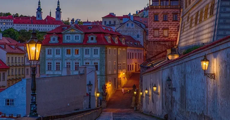 street lights lit up at dusk along a town street