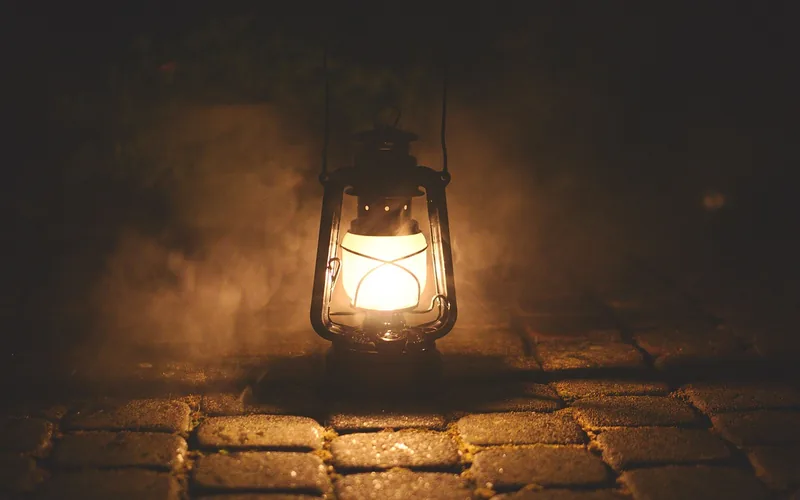 antique kerosene oil lamp glowing in the dark, the type of lighting used before gas street lamps