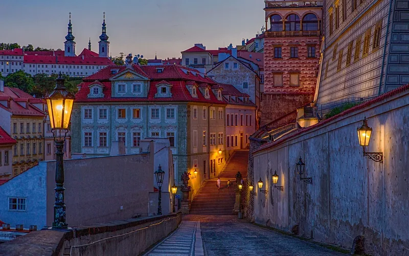 historic old town street at dusk lined with traditional street lamps