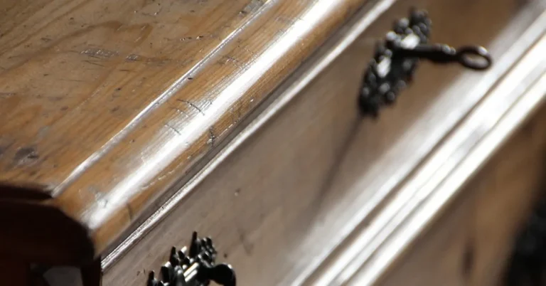 Close-up of wood furniture surface with visible water marks and stains