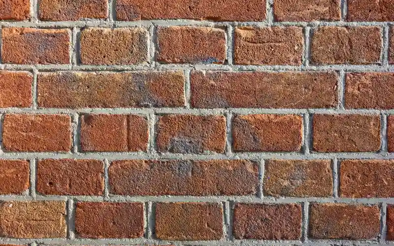 close-up of a brick wall showing recessed mortar joints suitable for no-drill clips