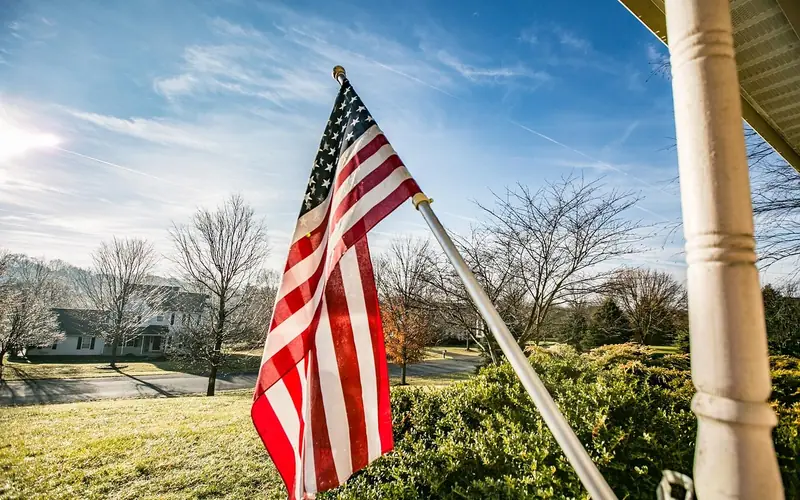 American flag mounted on an angled bracket attached to a porch column