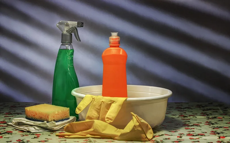 spray bottle, dish soap, sponge, and rubber gloves used for gentle countertop stain cleaning