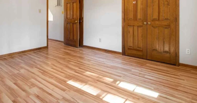 Empty room with newly leveled wood floor and refinished doors