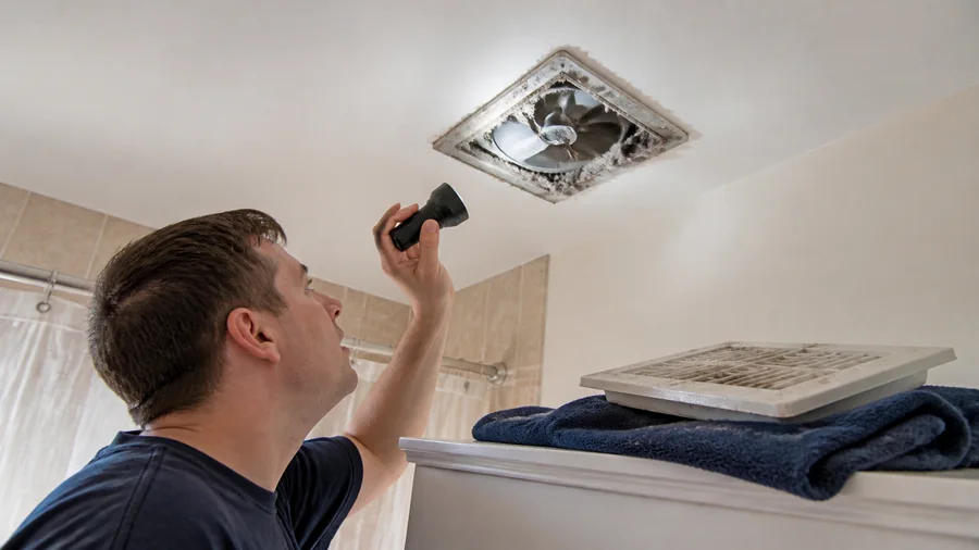 Bathroom exhaust fan grille and switch being checked during a no-power diagnosis