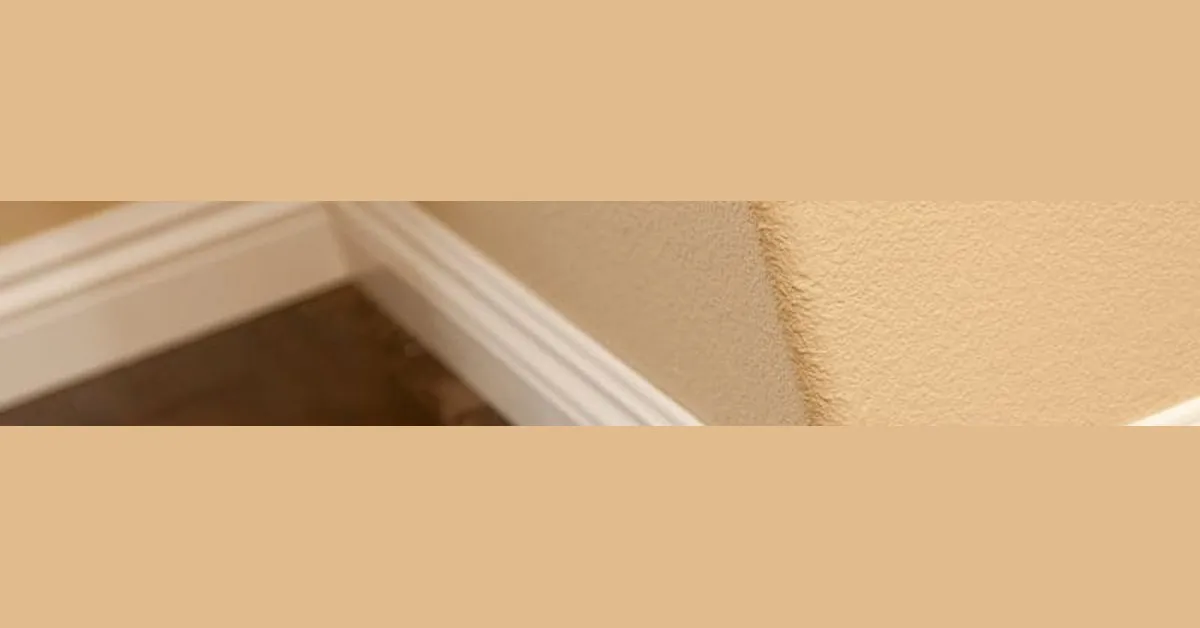 baseboard molding fitted against an uneven floor corner