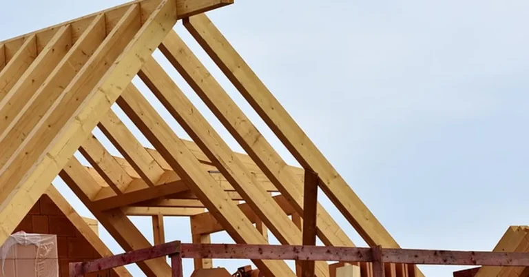 Freshly built wood roof rafters and trusses at a house construction site