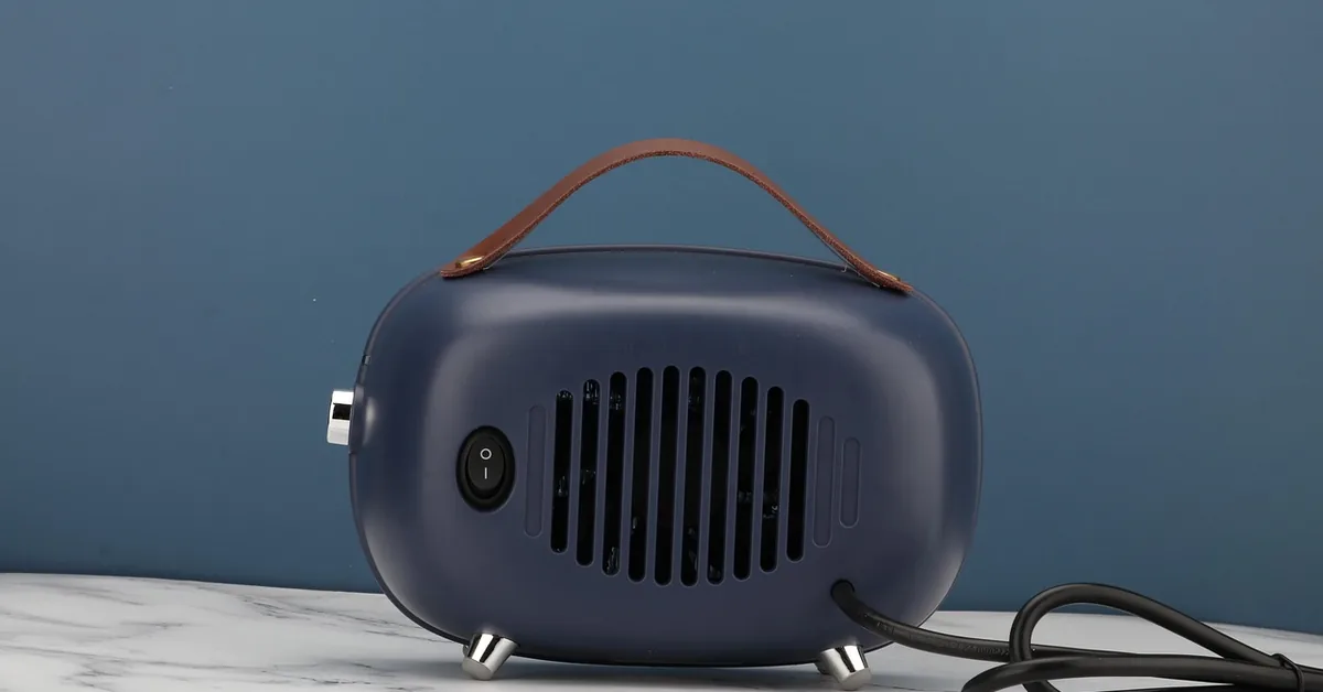 Ceramic electric space heater placed on the floor of a room
