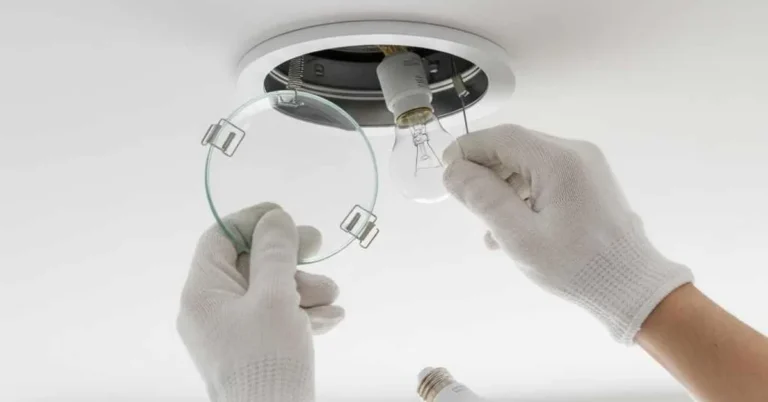 removing the glass lens cover to change a bulb in a recessed light