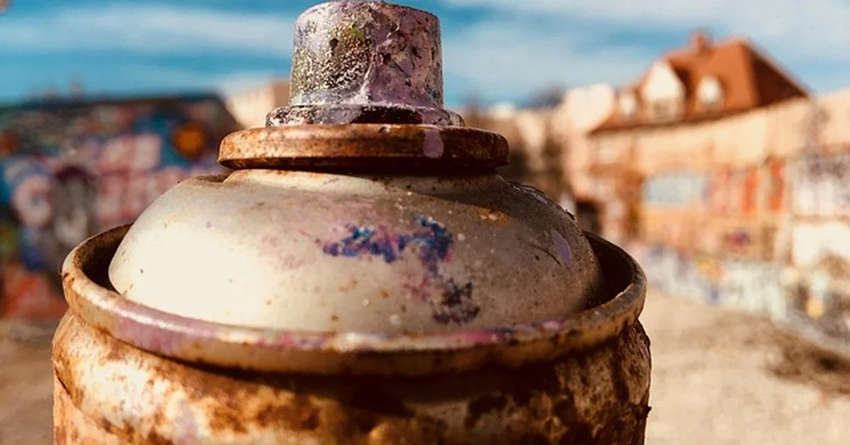 Clogged spray can nozzle with dried paint residue closeup