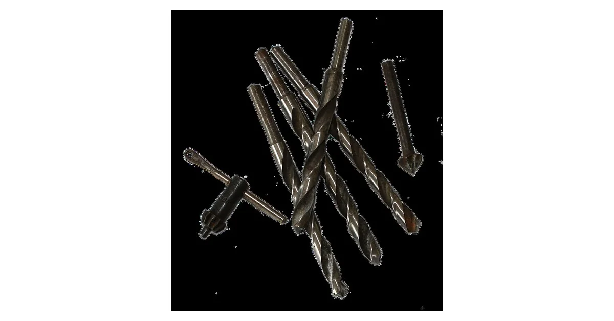 Set of countersink drill bits with chuck key on white background