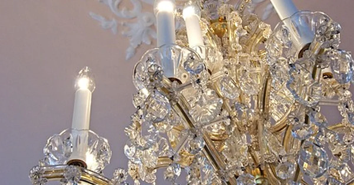 Crystal chandelier mounted on a decorative ceiling medallion before removal