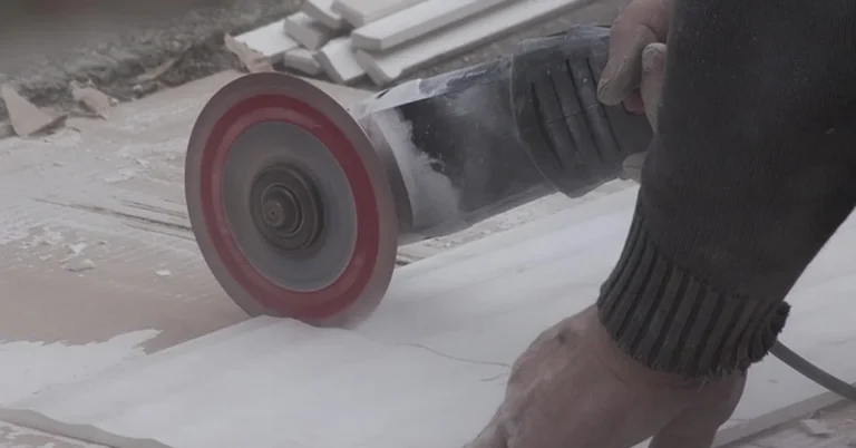 Diamond blade cutting a ceramic tile with an angle grinder