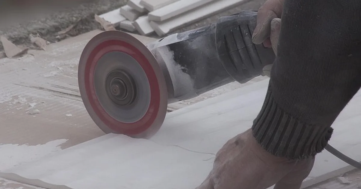 Diamond blade cutting a ceramic tile with an angle grinder