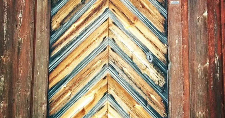 close up of wooden door hinge in frame showing the gap that needs fixing