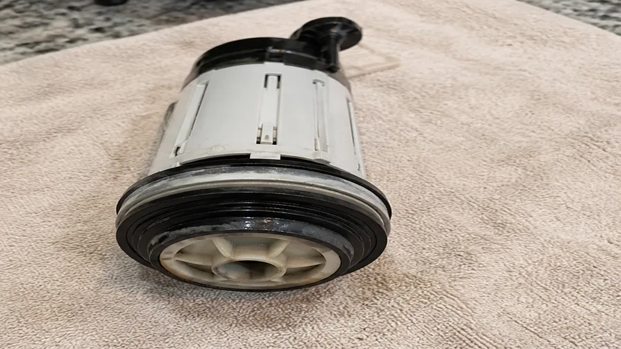 Dual-flush toilet tank with flush tower and seal inspected for a running-water problem