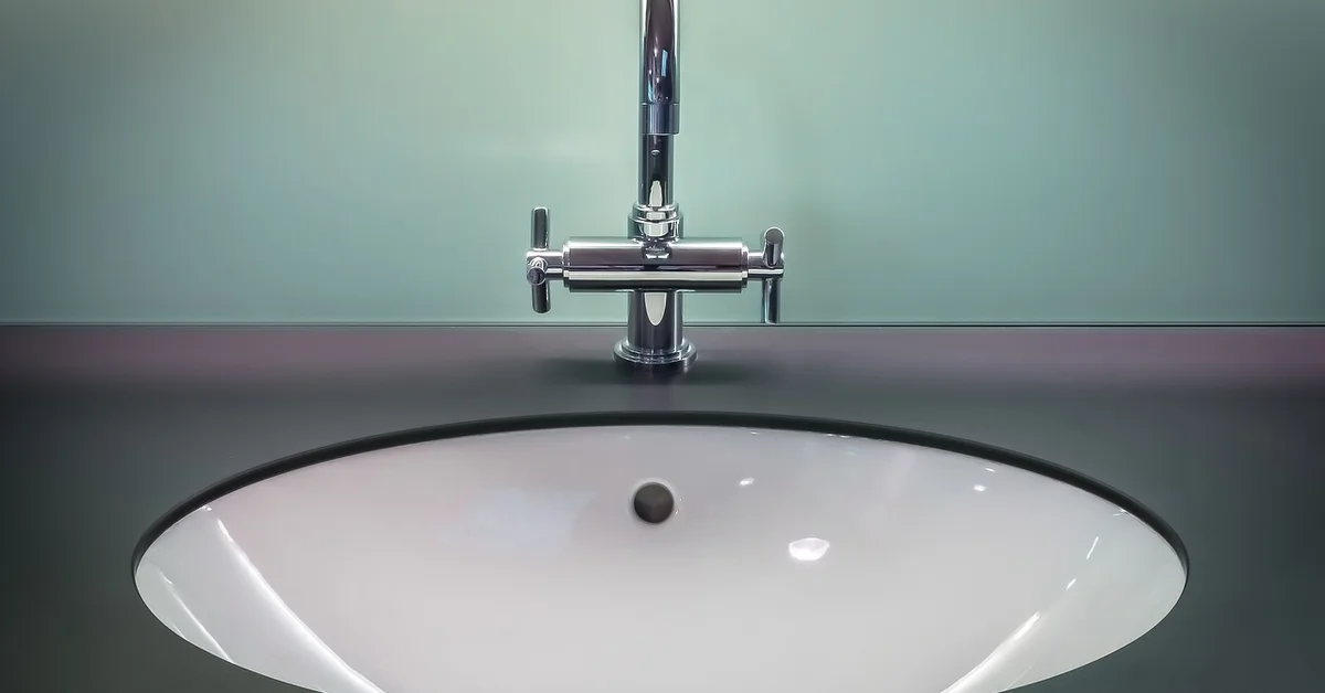 Chrome bathroom faucet ready for a vinegar soak to remove limescale
