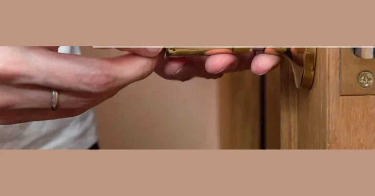 hands installing a door latch into the strike plate