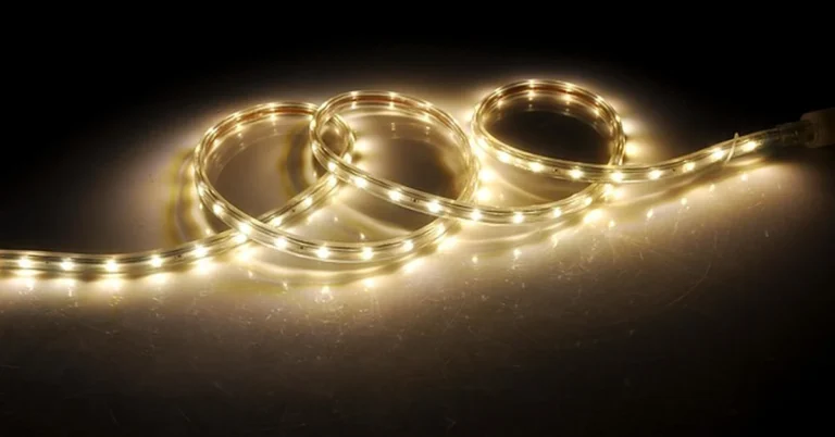 Coiled warm-white LED strip light showing individual diodes before hardwiring to a power supply