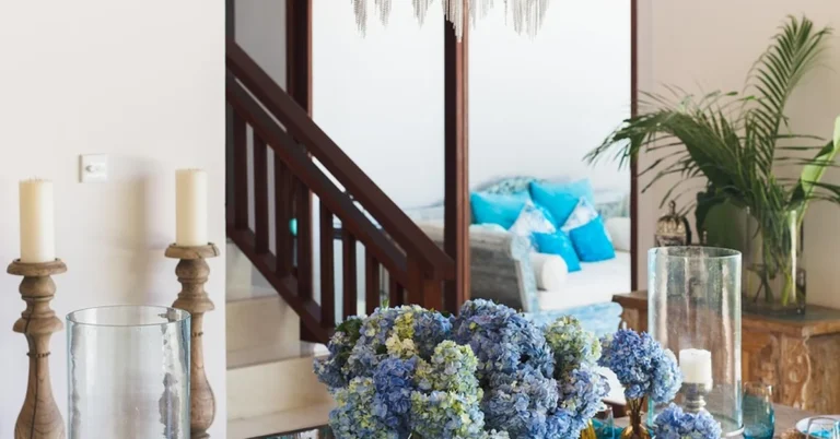 Modern chandelier hanging over a set dining table