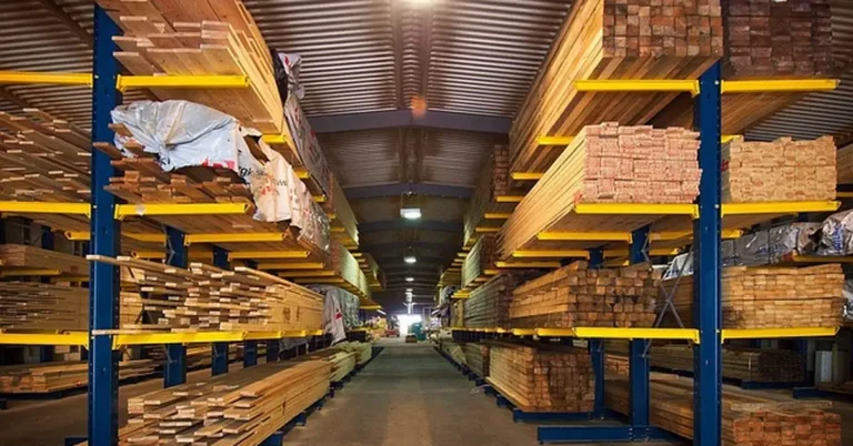 Stacked OSB and plywood sheets on warehouse racks at a lumber supplier