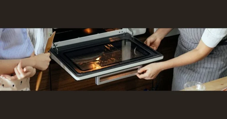 Oven door partially open at angle showing hinges before removal