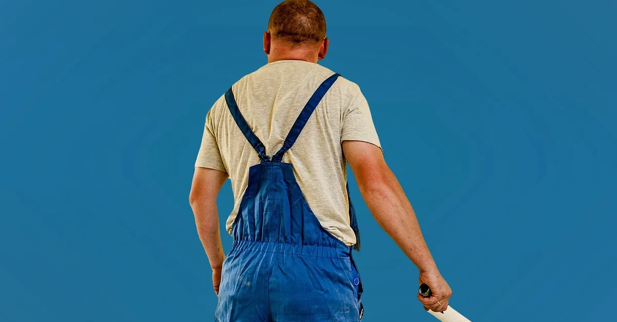 Painter renovating wall