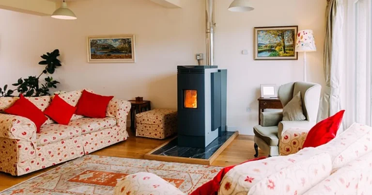 Freestanding pellet stove insert with vent pipe running up through the ceiling in a living room
