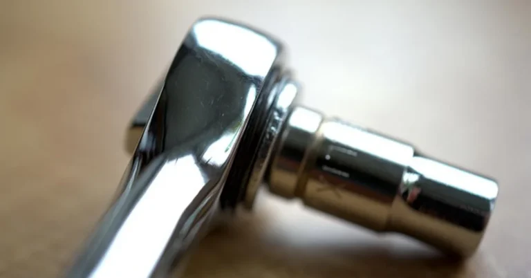 Chrome ratchet wrench head with socket attached
