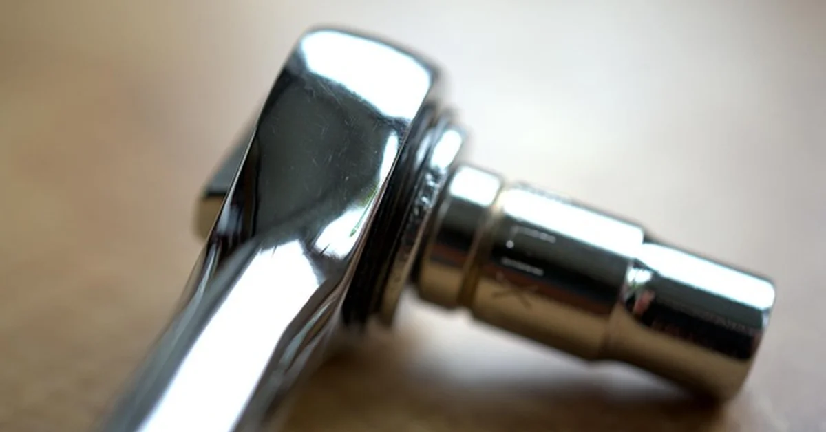 Chrome ratchet wrench head with socket attached