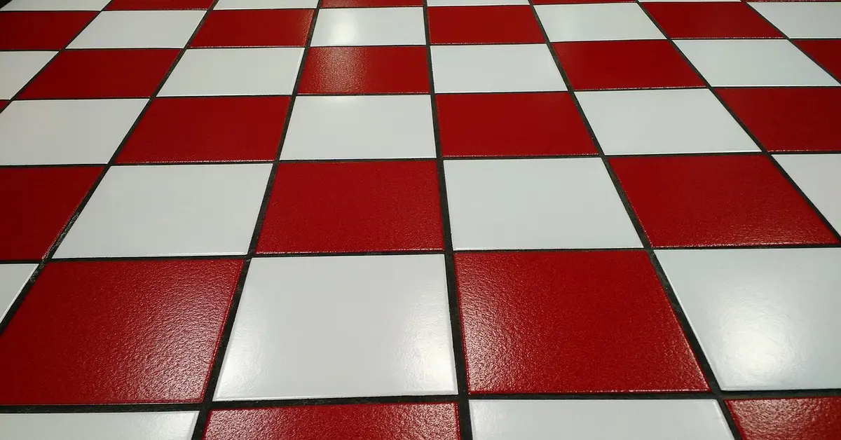 Red and white tile floor with visible grout lines between tiles