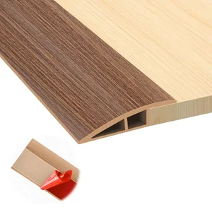 Self adhesive floor transition strip for doorway