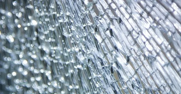 Close-up of shattered tempered glass broken into small blunt pieces